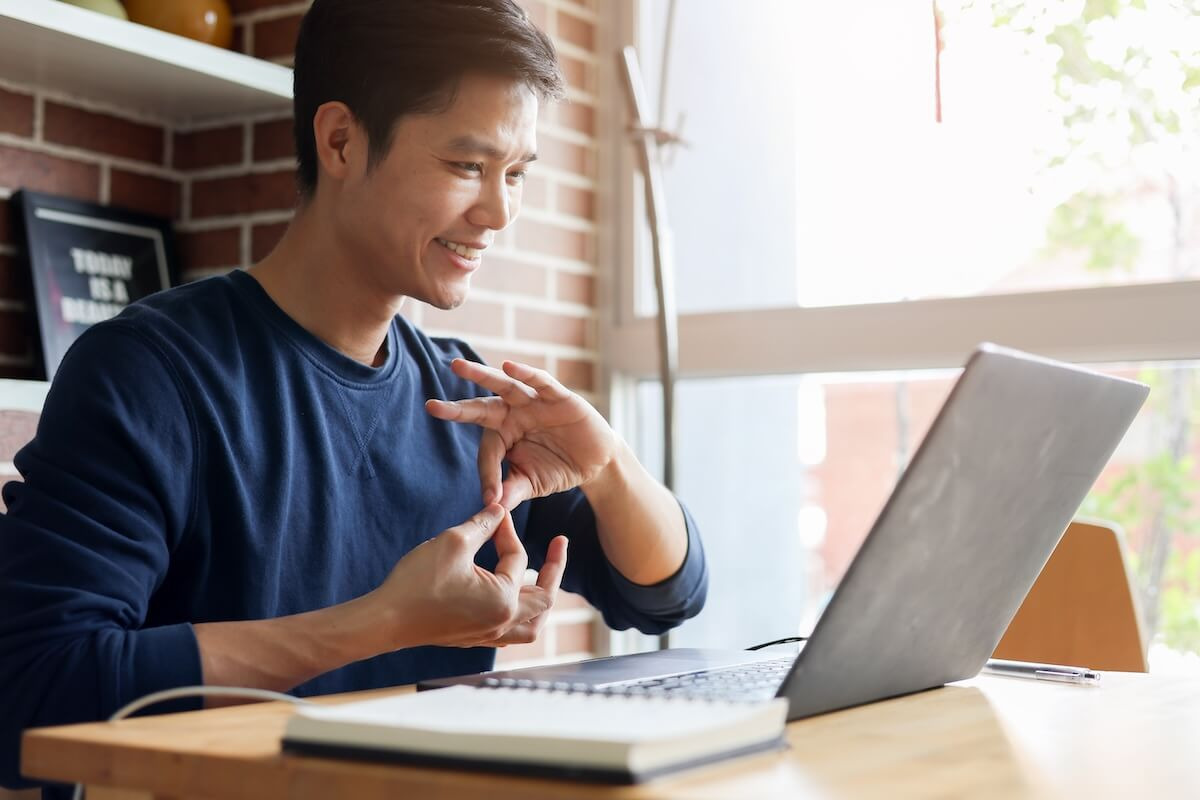 Employee using sign language during an online meeting