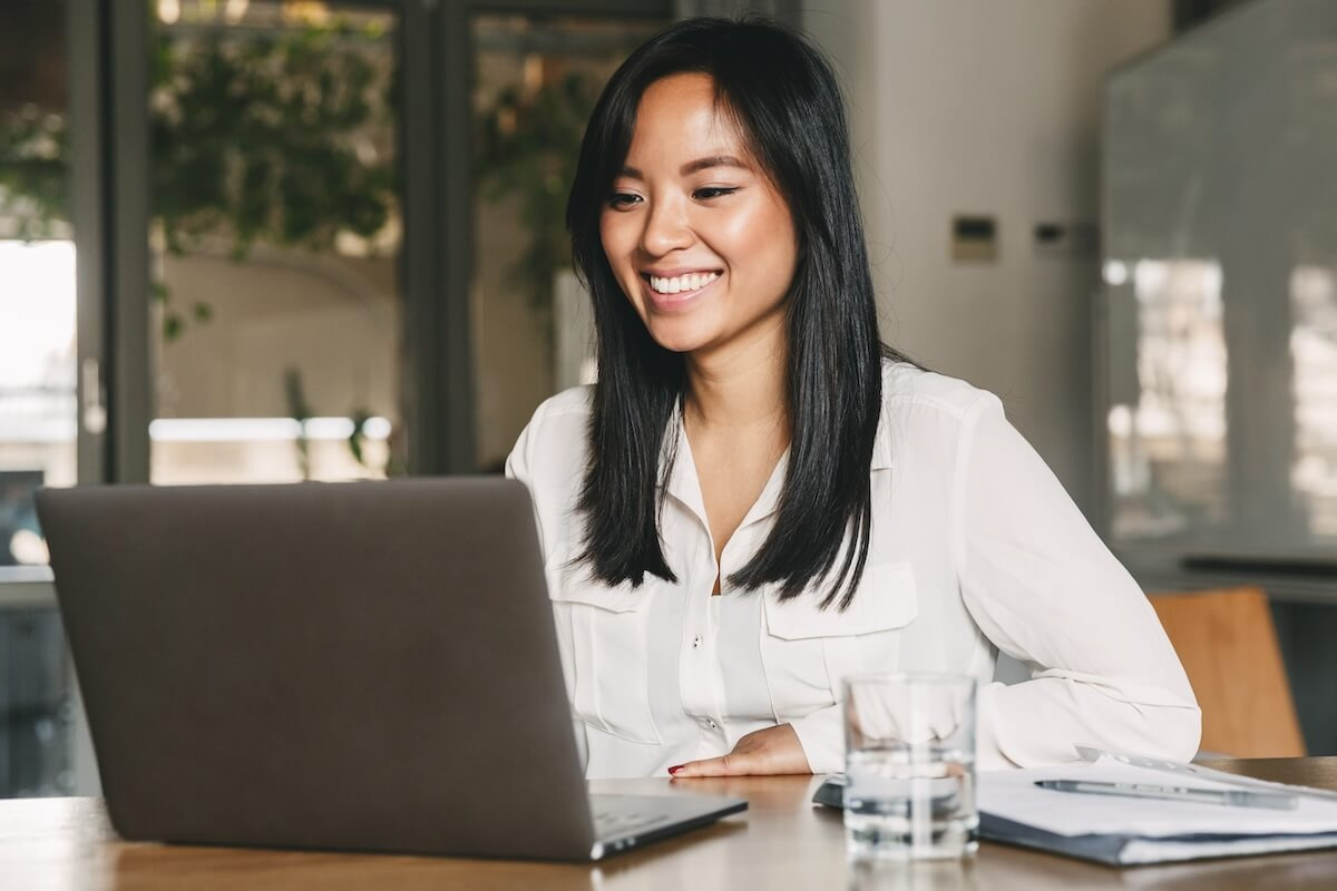 Entrepreneur happily using a laptop