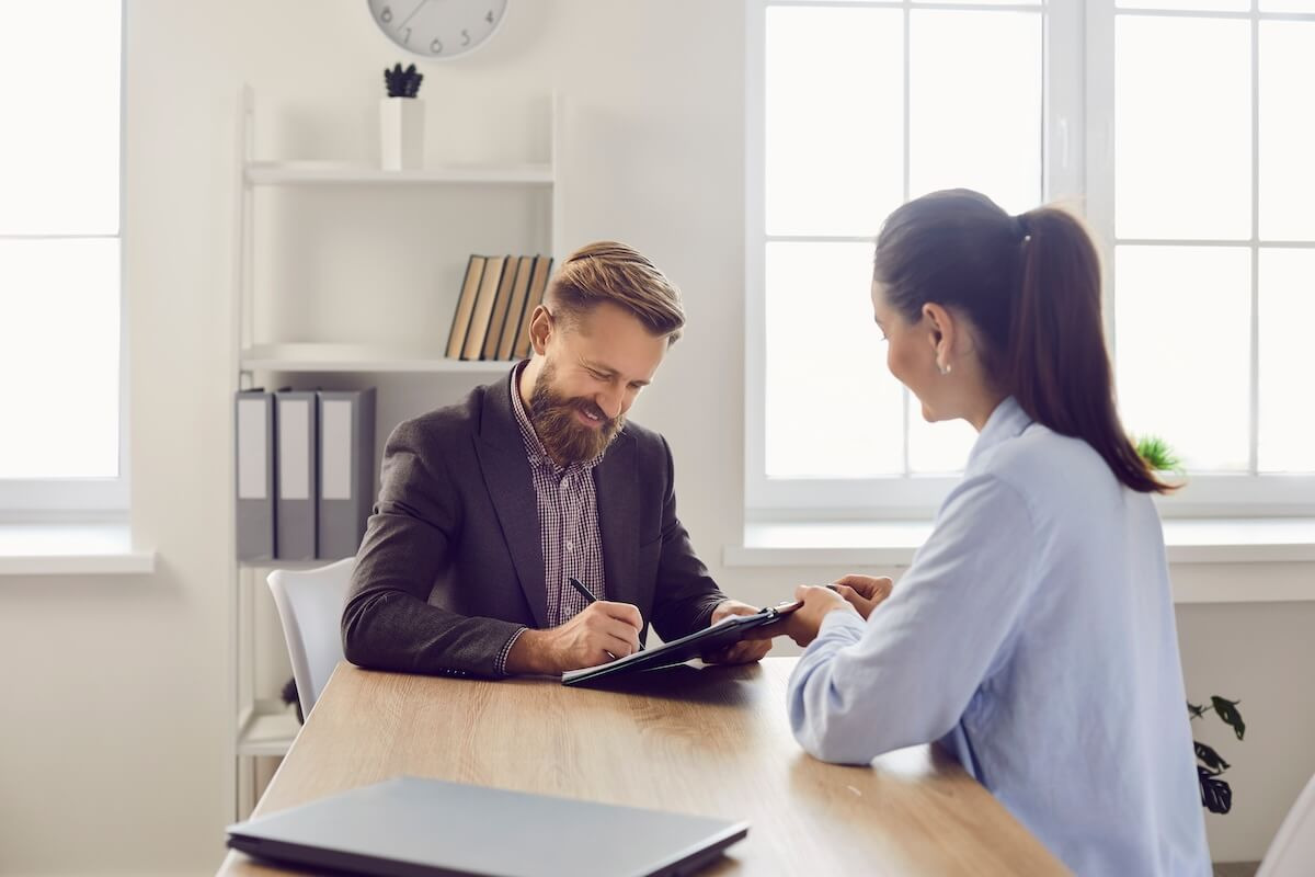 Employee happily signing a contract