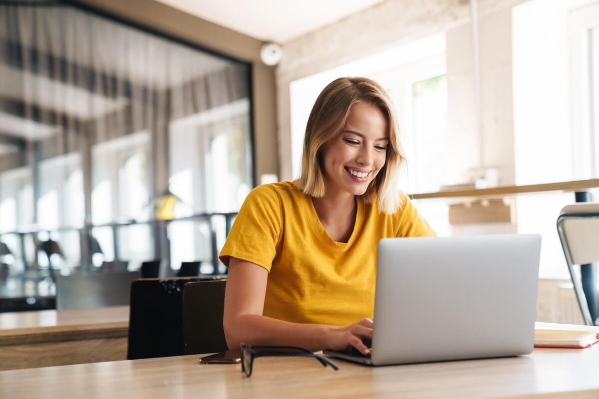 Entrepreneur happily using her laptop
