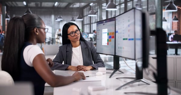Online leave management system: colleagues looking at a monitor