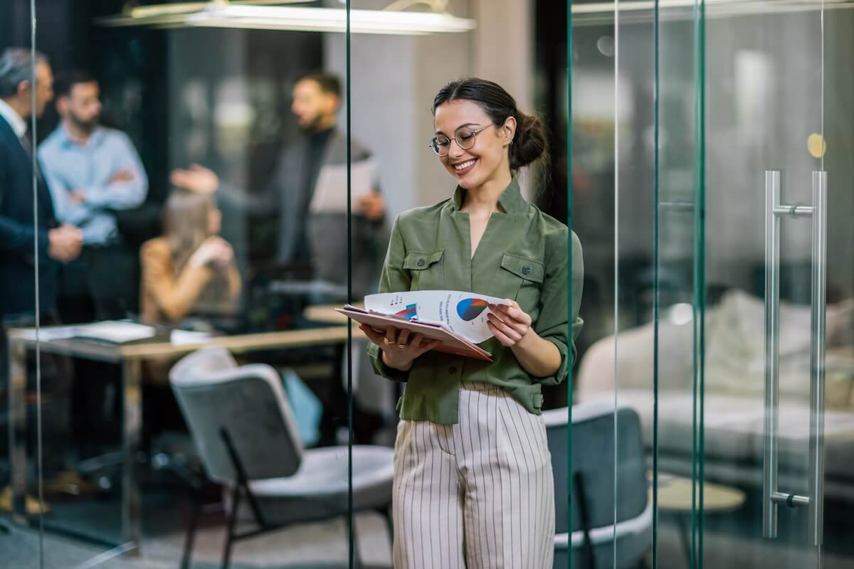 Employee happily looking at graphs and data