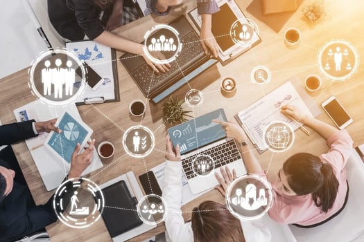 Automated leave management system: top view of a team meeting overlaid with connected digital icons representing communication and data
