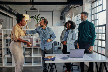 FMLA return to work guidelines: employees greeting their co-worker
