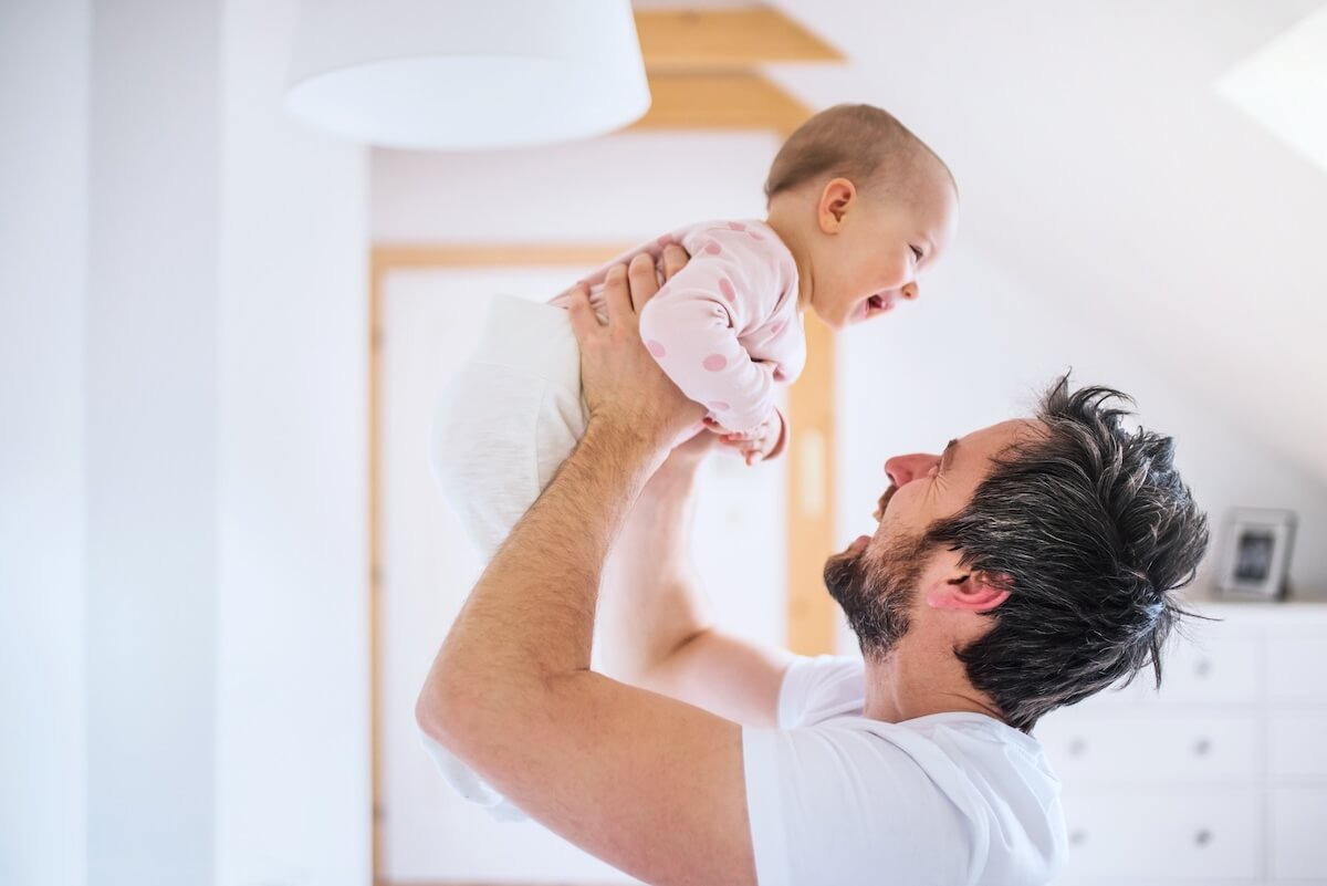 Types of leave of absence: father carrying his baby