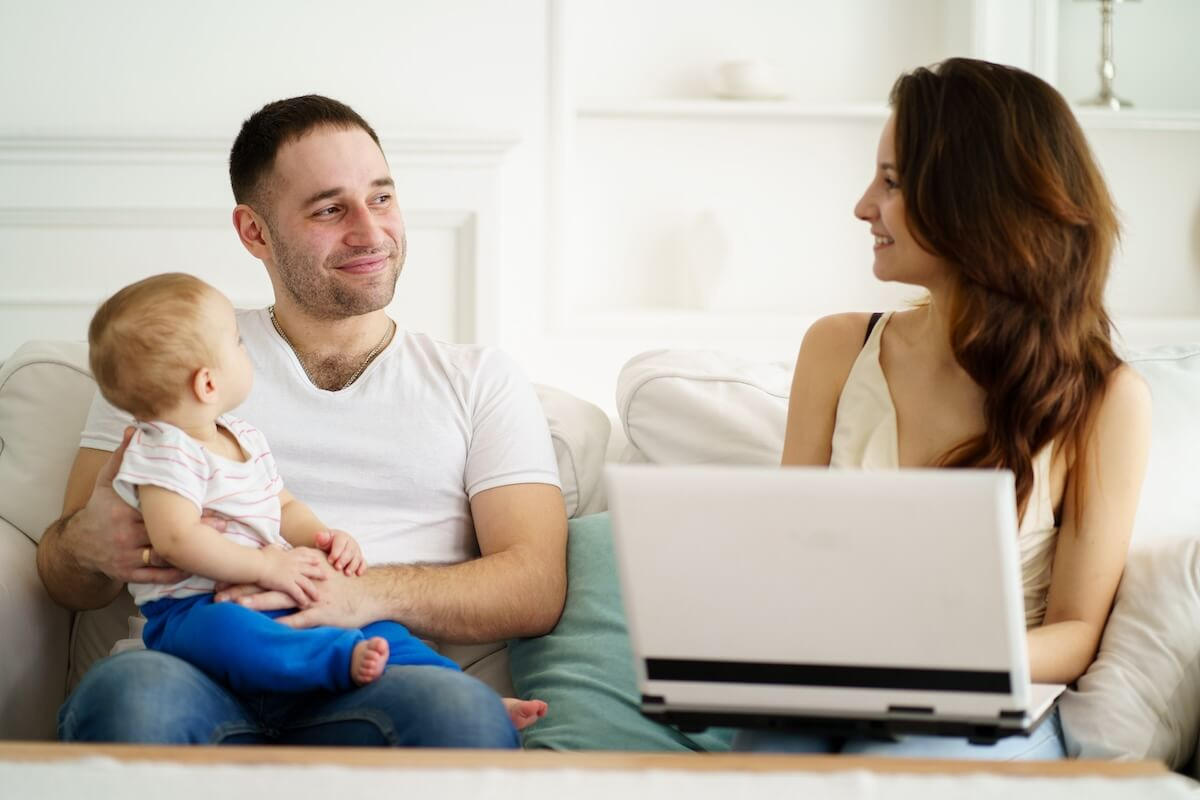 Father taking care of his baby while his wife is working from home