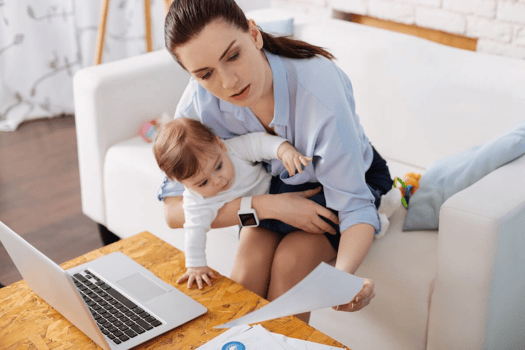 FMLA connecticut: employee holding a baby while working from home