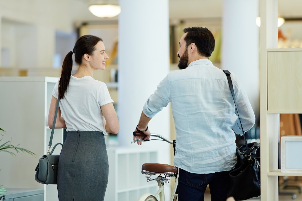 Back view of 2 colleagues talking while walking