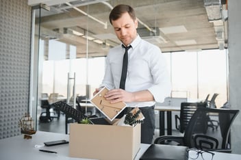 Managing employee absenteeism: employee putting his belongings in a box