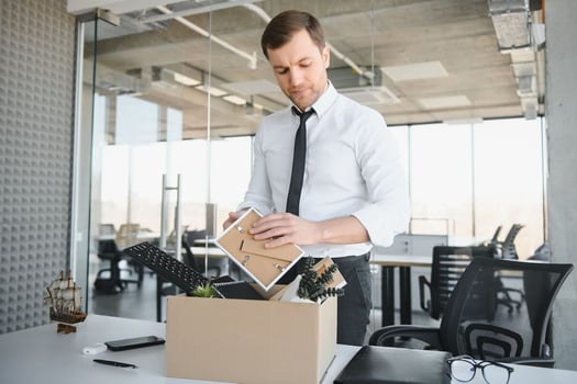Managing employee absenteeism: employee putting his belongings in a box