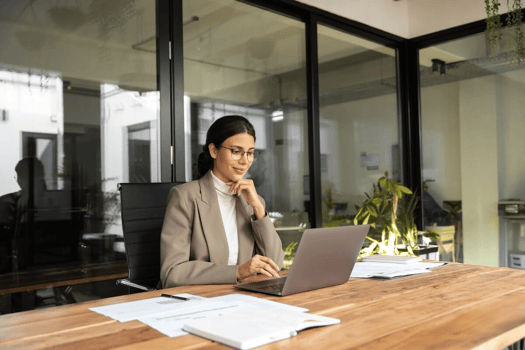 Scalable leave management: employee wearing a pair of eyeglasses, using a laptop