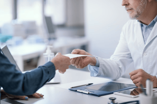 FMLA recertification: doctor giving a prescription to his patient