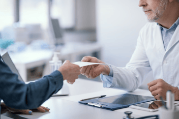 FMLA recertification: doctor giving a prescription to his patient