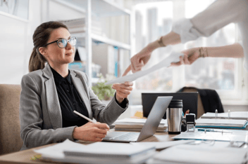 Policy violation documentation: HR manager receiving a document from an employee
