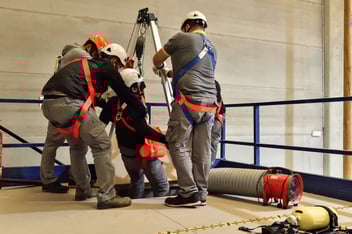 Unsafe working conditions: construction workers working together